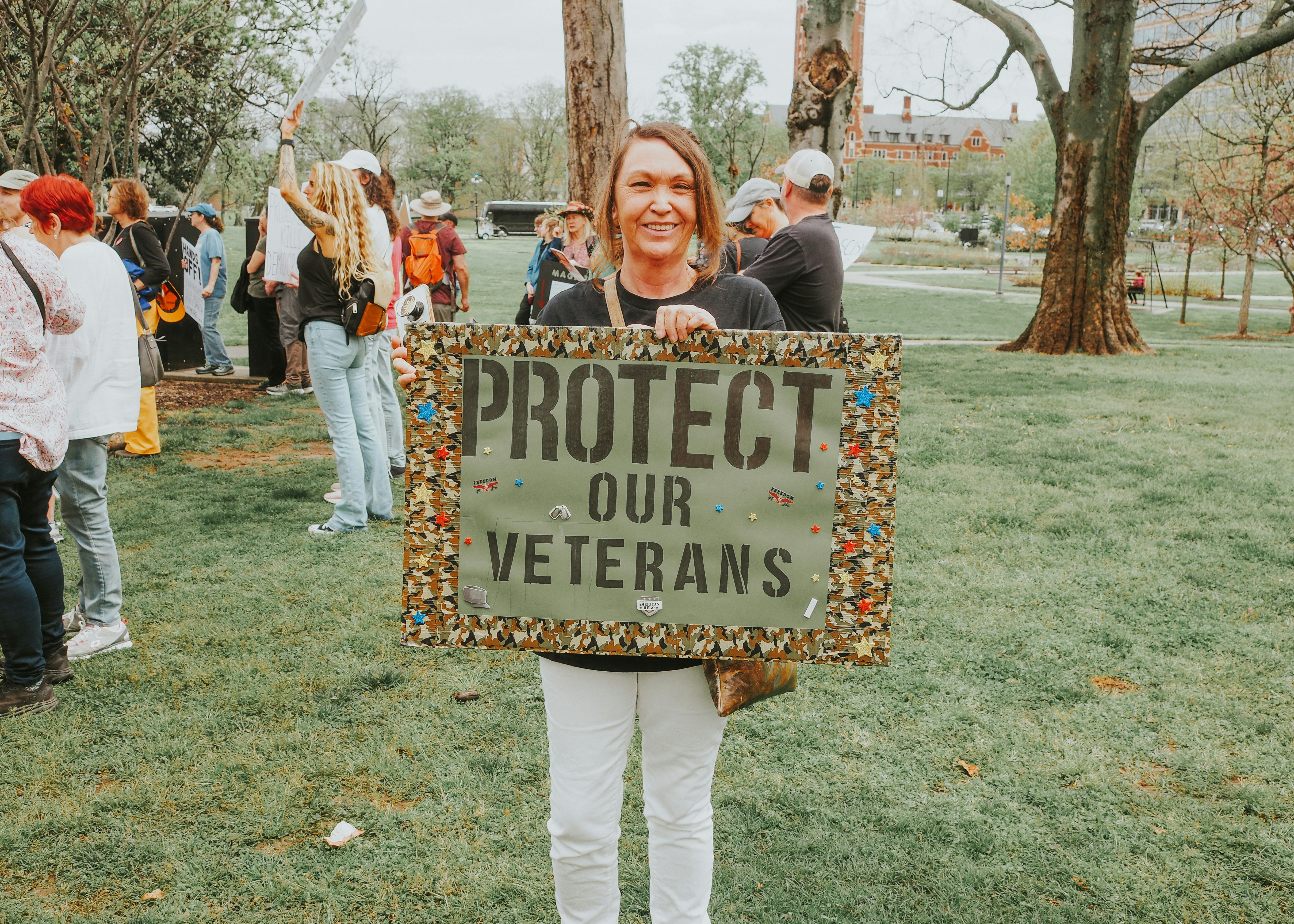 Woman holding sign to protect veterans
